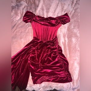 Red short velvet dress with extra fabric hanging on the side